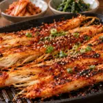 붉은 고추장 양념을 바르고 구운 섬유질 있는 더덕 뿌리